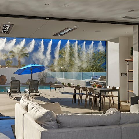 Soak up the views from the sofa, as the misting system cools the surrounding area 