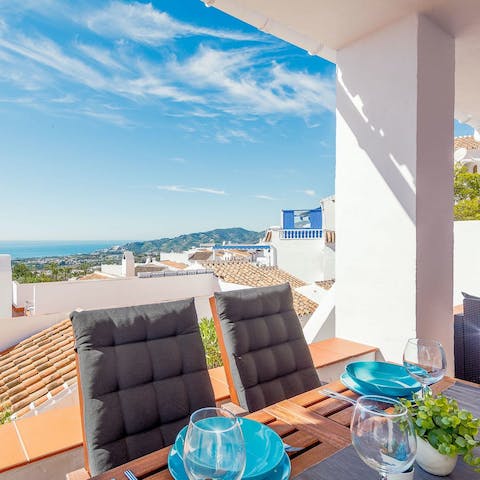 Gaze out over the mountains and houses to the sea from the terrace
