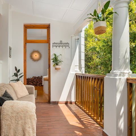 Gaze out at the greenery from the comfort of the sofa on the veranda