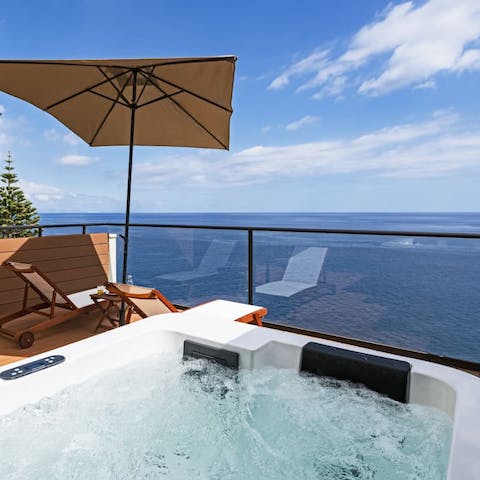 Soak in the hot tub on your private balcony, gazing out to sea