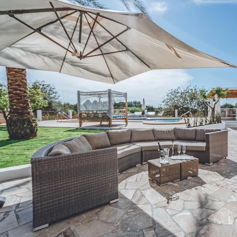 Lounge on the outdoor seating under the sun or in the shade of the parasol