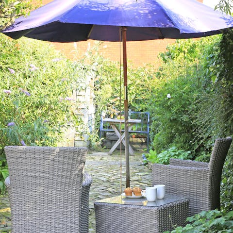 Enjoy your tea in the garden surrounded by a weeping pear tree, apple tree and mature roses