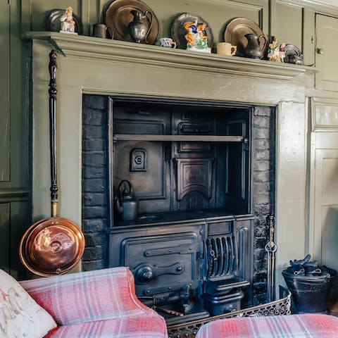 Marvel at the ancient working range in the wood-panelled living room