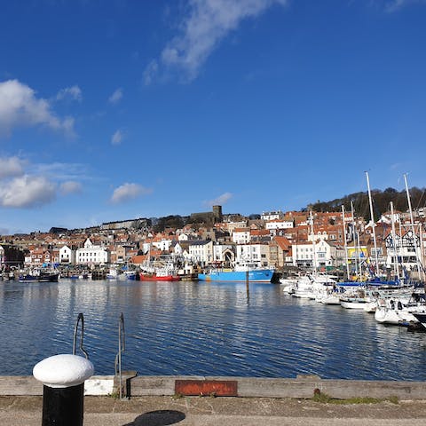 Visit Scarborough Harbour and eat fresh fish and chips while watching the boats bob