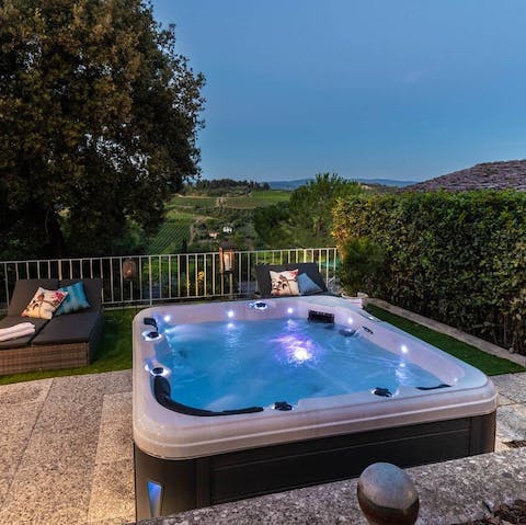 Admire the gorgeous countryside views from the bubbles of your private hot tub