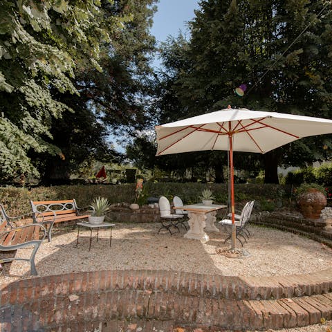 Gather around bowls of fresh pasta as you dine under the umbrella