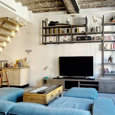 Unwind in the loft-style living area, filled with books, games, and films