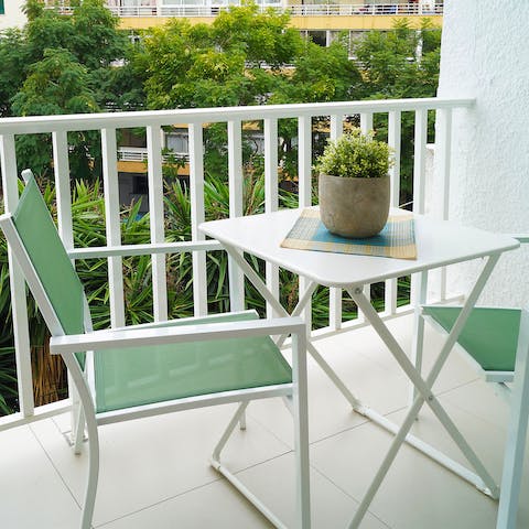 Relax on your private balcony overlooking the palms