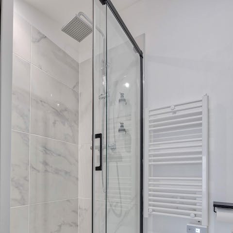 Enjoy a relaxing soak under the rainfall shower after a day of sightseeing