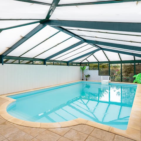 Enjoy the beautiful indoor pool no matter the weather, with views of the lush garden