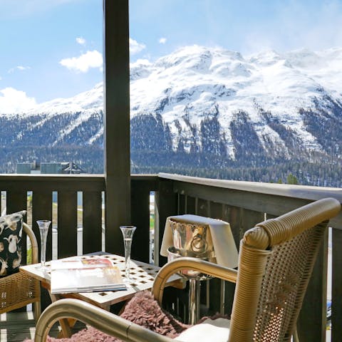 Enjoy a glass of bubbly on the balcony with views of St Moritz's mountains