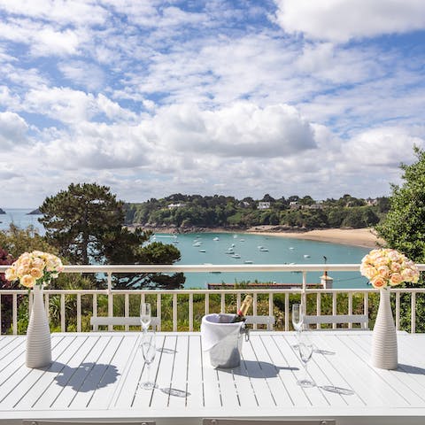 Pour a glass of fizz and admire the views over the bay from the balcony 