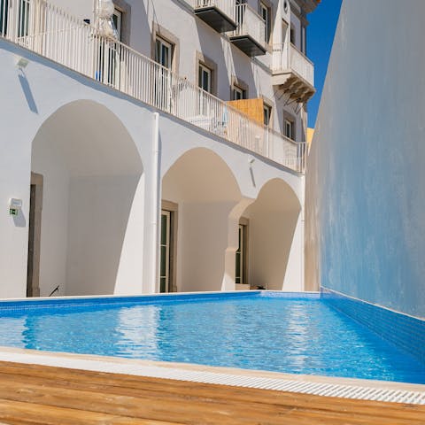 Slide into the refreshing communal pool after a day of exploring
