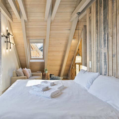 Drift off to sleep in the comfy bedrooms underneath A-frame, timber-clad ceilings