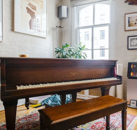 Bash out a tune on the beautiful baby grand piano