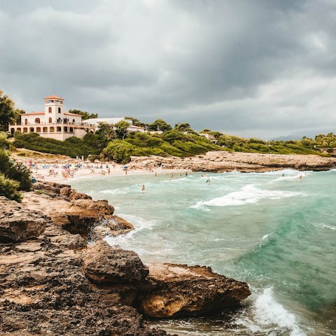 Take a drive to nearby Alcúdia beach and sink your feet into the sand