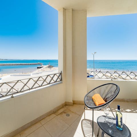 Admire views across the bay of Lagos from the private balcony