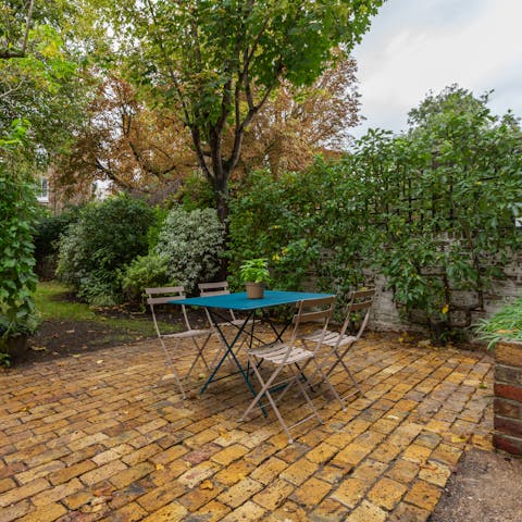 Dine alfresco in the leafy and secluded garden setting 