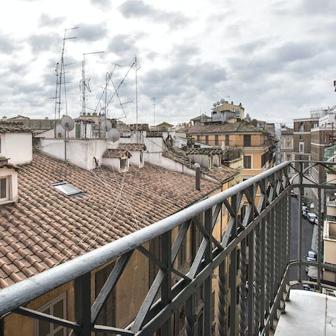 Admire breathtaking views of Rome's rooftops from the private balcony