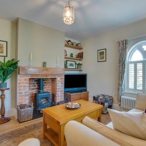 Snuggle up in the cosy living room in front of the wood-burner