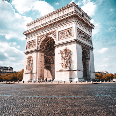 Stroll along the avenue to visit the iconic Arc de Triomphe