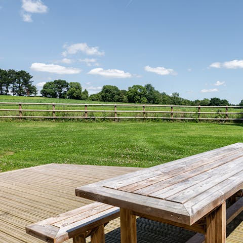 Admire views of green pastures and the large, fenced garden from the deck