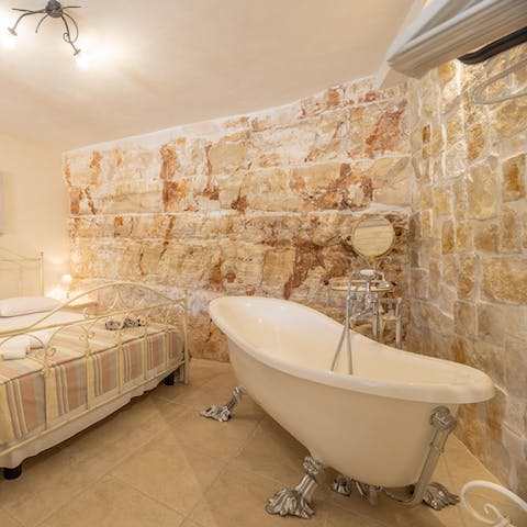 Unwind in the claw-footed tub of the main bedroom at the end of the day