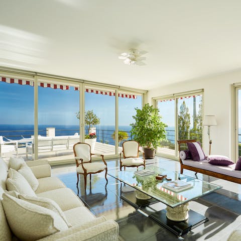 Relax with loved ones on your sumptuous sofas, as blue views wrap around you