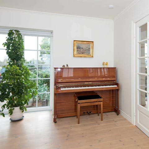 Practise a jaunty tune on the upright piano in the lounge