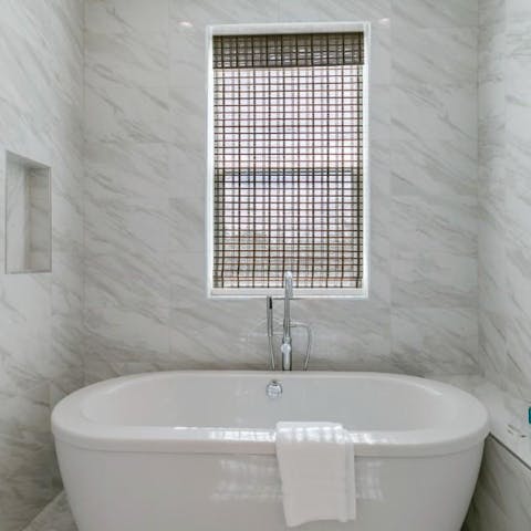 Slope away for a soak in the freestanding bathtub