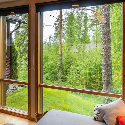 Admire the forest views as you sip a cup of coffee on the sofa