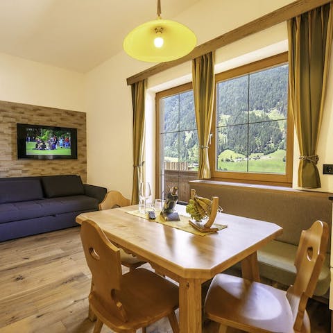 Eat, drink and be merry in the warm, wooden living room while admiring mesmerising mountain views