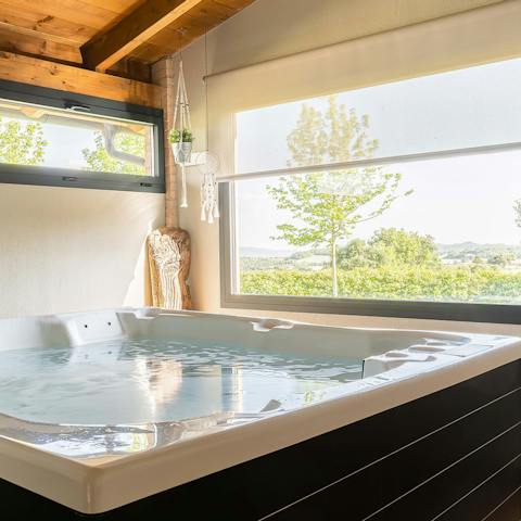 Relax in the luxurious hot tub while gazing out of the window at the calming vistas 