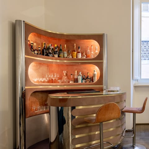Whip up cocktails in the home's stylish corner bar