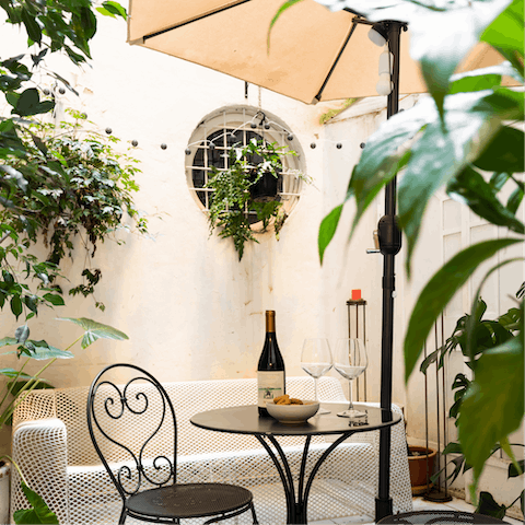 Pour yourself a glass of wine in the private courtyard