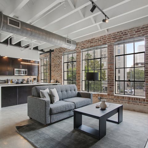 Relax in your own loft-style apartment while gazing at the streets below