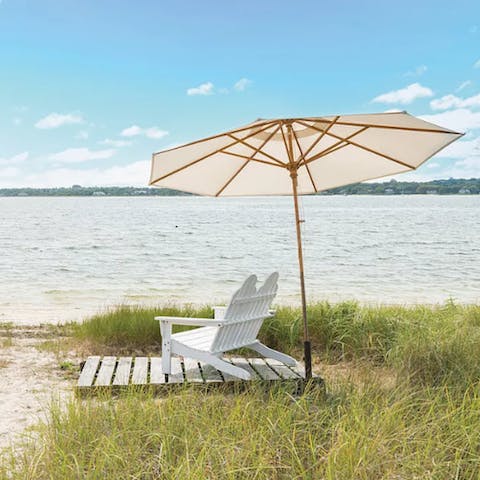 Relax on deck chairs under a shady umbrella