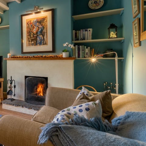 Get cosy by the wood-burning fire after picking a book from the host's collection