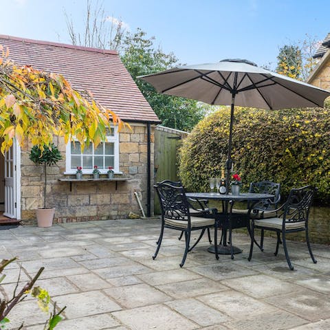 Gather under the parasol on a sunny afternoon for a chilled bottle of champagne