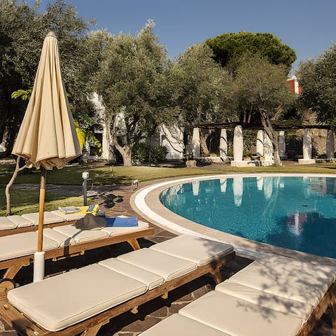 Catch some sun by the large pool, surrounded by expansive gardens