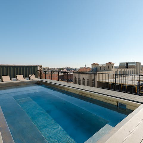 Laze on sun loungers or go for a dip in the building's rooftop swimming pool
