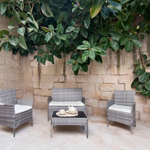 Toast a productive day with an aperitivo on the home's leafy patio