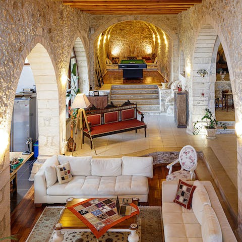 Sink into your sofa and take in the magnificence of the stone-vaulted ceiling