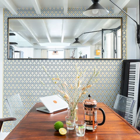 Savour your morning coffee on the dining table by the geometric feature wall