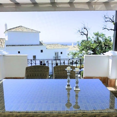 Dine as you look out over the white houses to the shimmering sea beyond