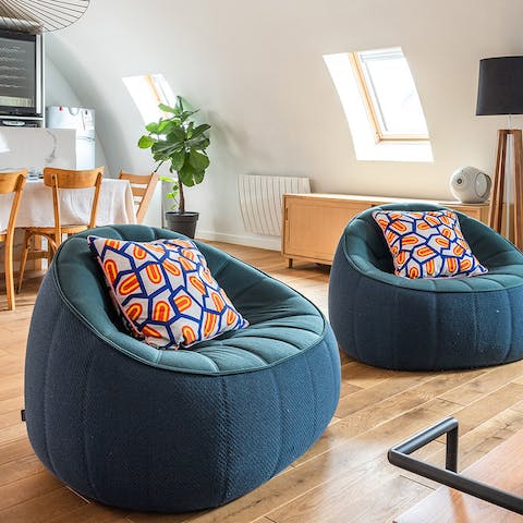 Settle into the squishy retro armchairs