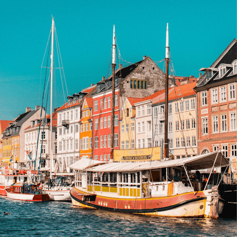 Sip a beer overlooking the water and colourful buildings of Nyhavn – it's half an hour on the harbour bus, or just over ten minutes by bike