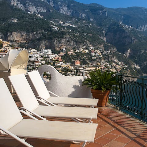 Relax with a good book on a sun lounger while you take in the views of Positano
