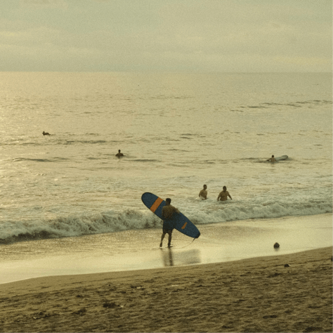 Catch some waves at Seminyak Beach