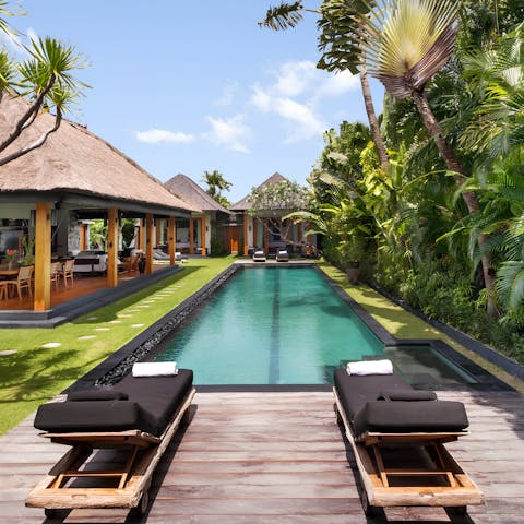 Spend the afternoon lazying in the tropical garden by the private pool